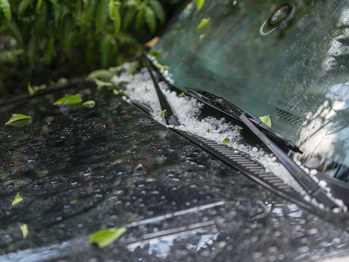 Large hail ice balls on car hood after heavy summer storm